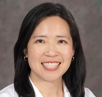 Elisa Tong wearing a white coat