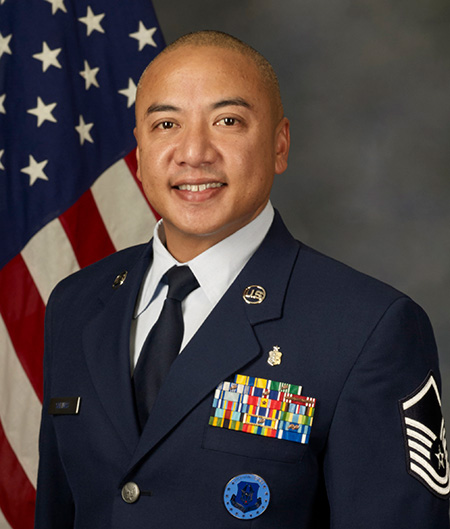 MSgt Salinas in U.S. Air Force uniform, American flag in background