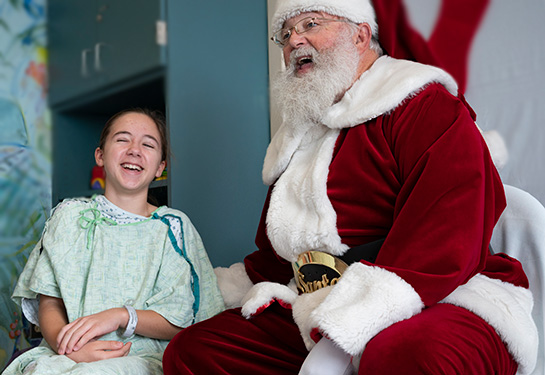 Male patient laughing with Santa