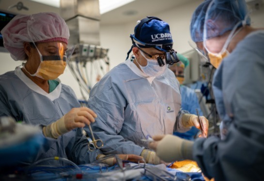 Surgeon standing over patient during surgery