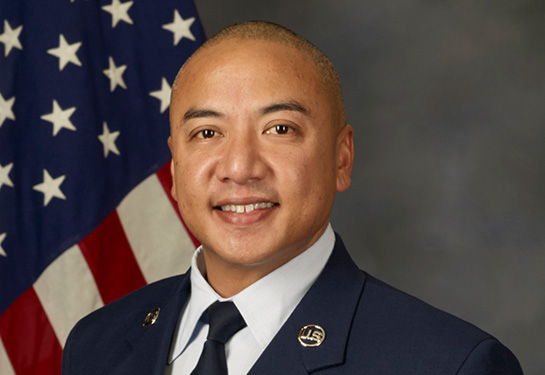 MSgt Salinas in U.S. Air Force uniform, American flag in background