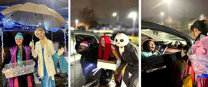 Two people in costume – one dressed as Elsa from “Frozen”, A young girl leans out of a black SUV, laughing, gift accepted from people dressed in Christmas costumes