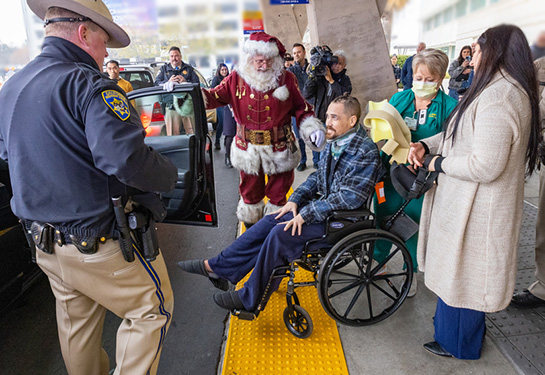 Aaron Weikert gets into a highway patrol car next to Santa Clause
