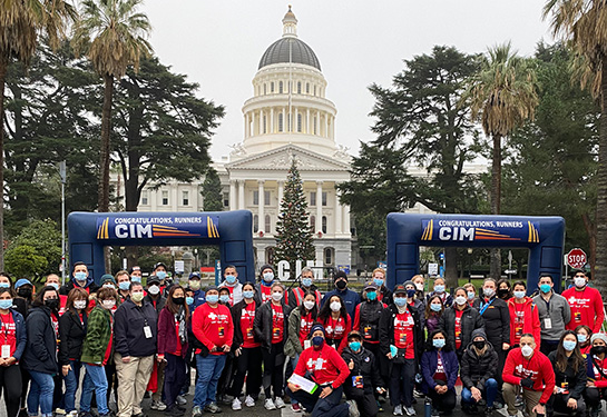 2.	UC Davis Health medical volunteers pose near the CIM finish line in front of the State Capitol.