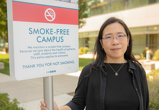 Elisa Tong standing next to no smoking sign