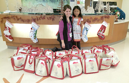 Annabelle and a child life staff member with gift bags in front of them