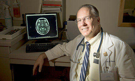 Dr. DeCarli with a brain scan on his computer