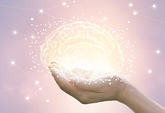 graphic illustration of a hand holding a brain with stars around it