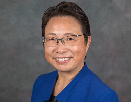 Woman wearing blue sport coat and smiling