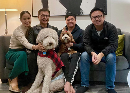 A family portrait shows Matthew seated with his mother, Elizabeth; father, Primo; brother, Joshua; and their dogs Fudge and Momo  