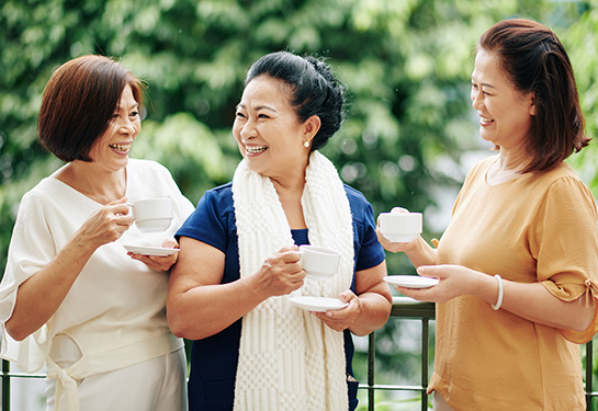 Senior female friends drinking tea outside