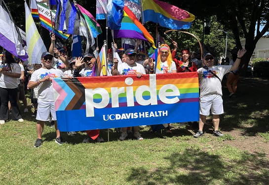 UC Davis Health parade participants hold banner