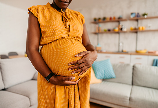 Pregnant black woman in an orange dress