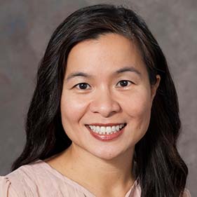 Dr. Oanh Meyer, a neurologist at UC Davis Health and an Asian-American with black hair, smiling and wearing a peach-colored blouse.