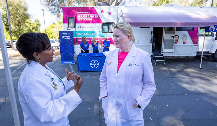 Janine Bera (left), chief medical officer for WellSpace Health, talks to Elizabeth Morris (right)