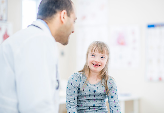 Patient with Down Syndrome speaking with doctor