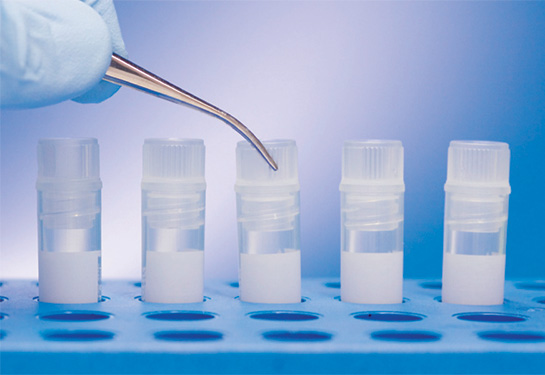Five plastic tubes with middle tube being filled