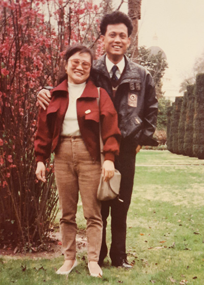 Old photo of Asian American woman on left pictured with Asian American man on right.