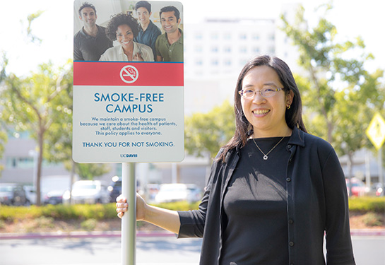 Elisa Tong next to stop tobacco sign