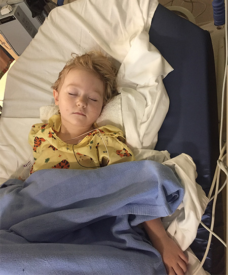 Young child in a hospital bed sleeping