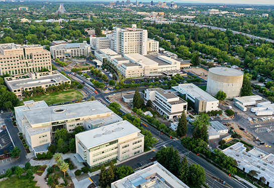 Aerial view of the UC Davis Medical Center campus with downtown Sacramento skyline in the distance