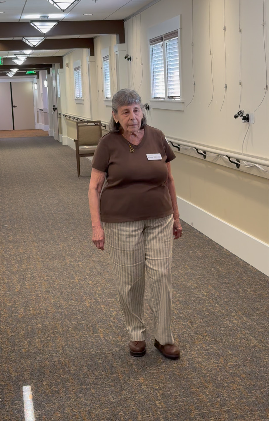 Woman walking in hallway where cameras are mounted on walls