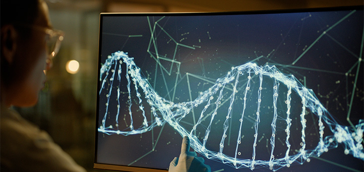 Scientist pointing to a screen with a DNA helix