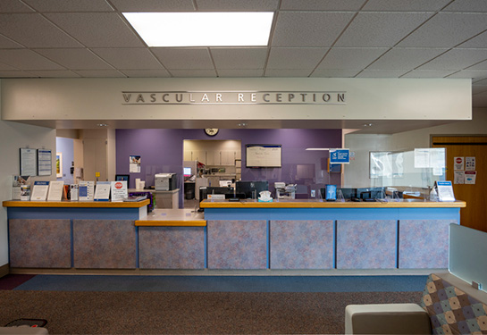 Reception desk with sign overhead saying Vascular Reception 