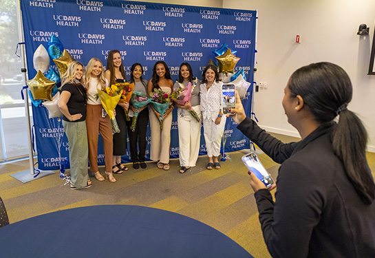 An employee taking a picture of a group of colleagues.