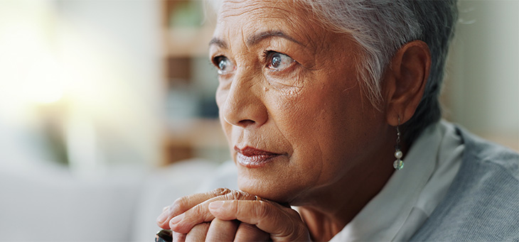 An older lady with short hair looking far