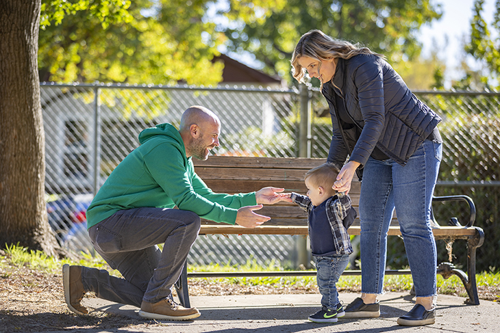 Dad reaching out to son who's walking toward him