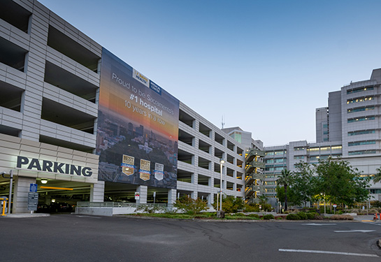 The parking structure with the medical center in nearby background