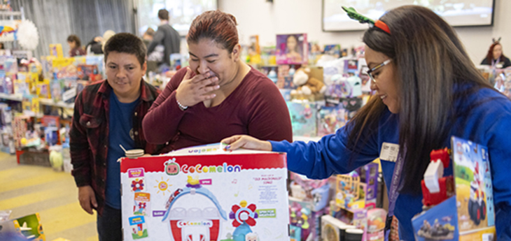 Woman and boy shop for toys. 