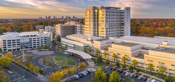 Aerial view of UC Davis Medical Center during the day with the skyline of Sacramento in the distance.