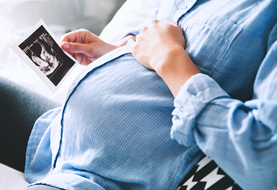 Pregnant patient holding belly