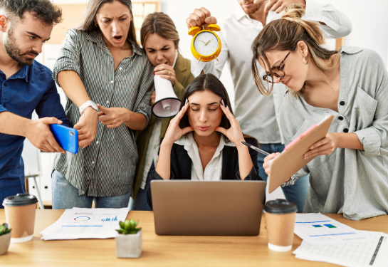 Group of business workers screaming at stressed partner at the office.