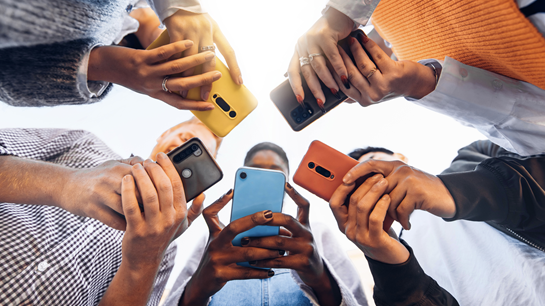 people gathered and using their mobile devices