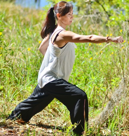 Woman standing in tai chi warrior pose