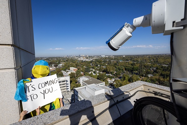 A falcon mascot holds a sign reading &ldquo;IT&rsquo;S COMING TO YOU...&rdquo; beside the falcon camera.