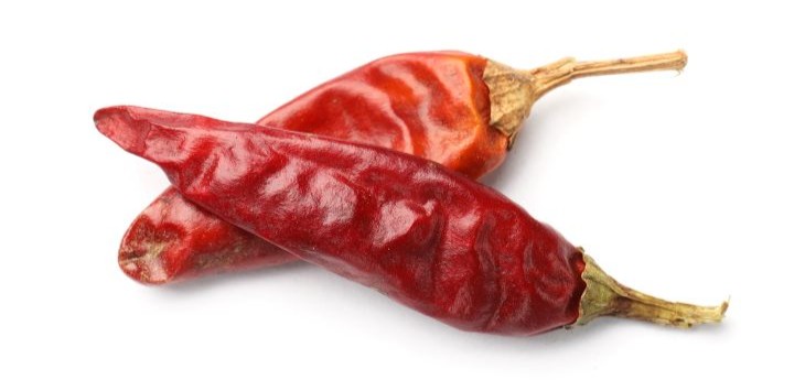 Two dried red chili peppers, a natural source of capsaicin, on a white background.