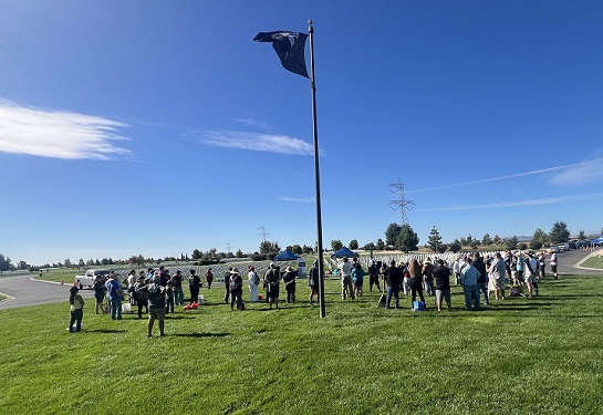 A group of volunteers at a cemetery clean up event