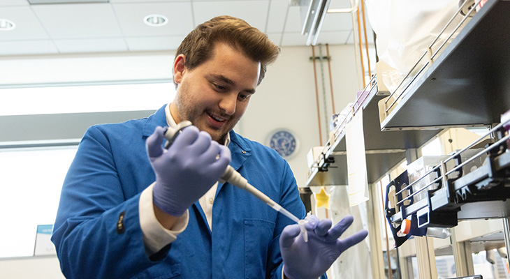 Biomedical engineering graduate student prepares a tube to synthesize an extracellular vesicle protein.