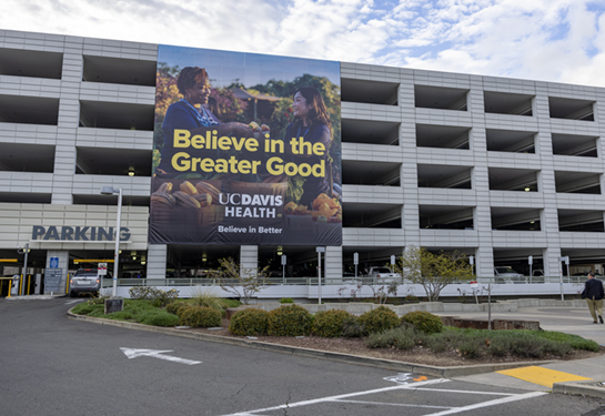 The Believe in Better banner on a parking structure.