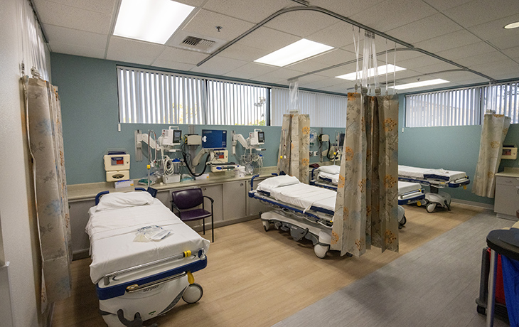 Four hospital beds and clinical machinery