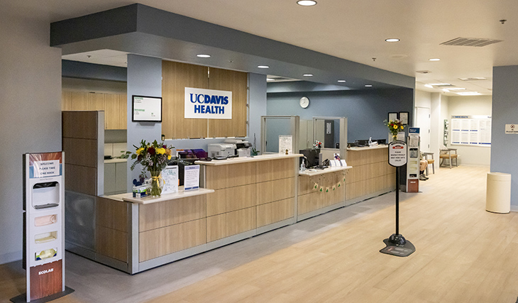 Reception and clinic waiting area with UC Davis Health signage