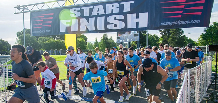 People begin running the race at the start line.