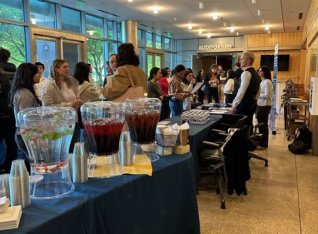 Attendees gather in the lobby to talk with refreshments