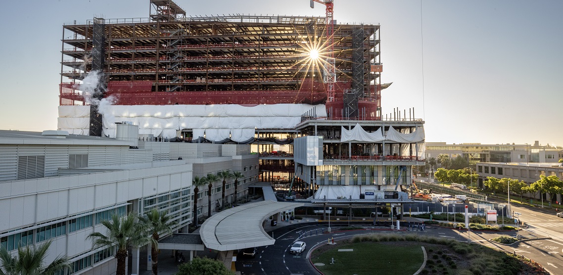 The sun shines through the scaffolding of the California Tower construction