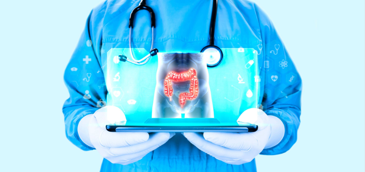 Doctor wearing a stethoscope holds a tablet projecting the human large intestine on the screen.