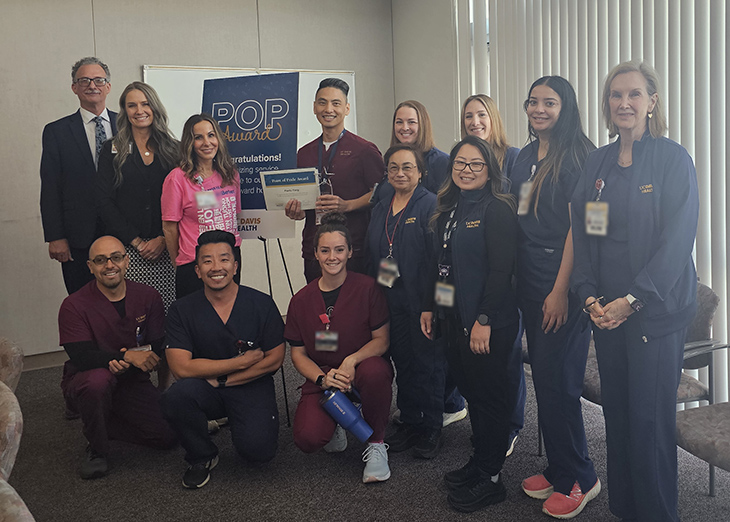 Group of clinicians and staff in conference room